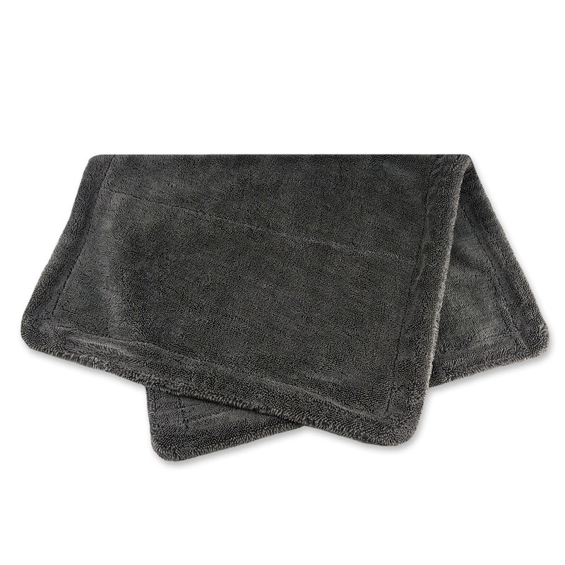 Folded dark gray towel on a white background