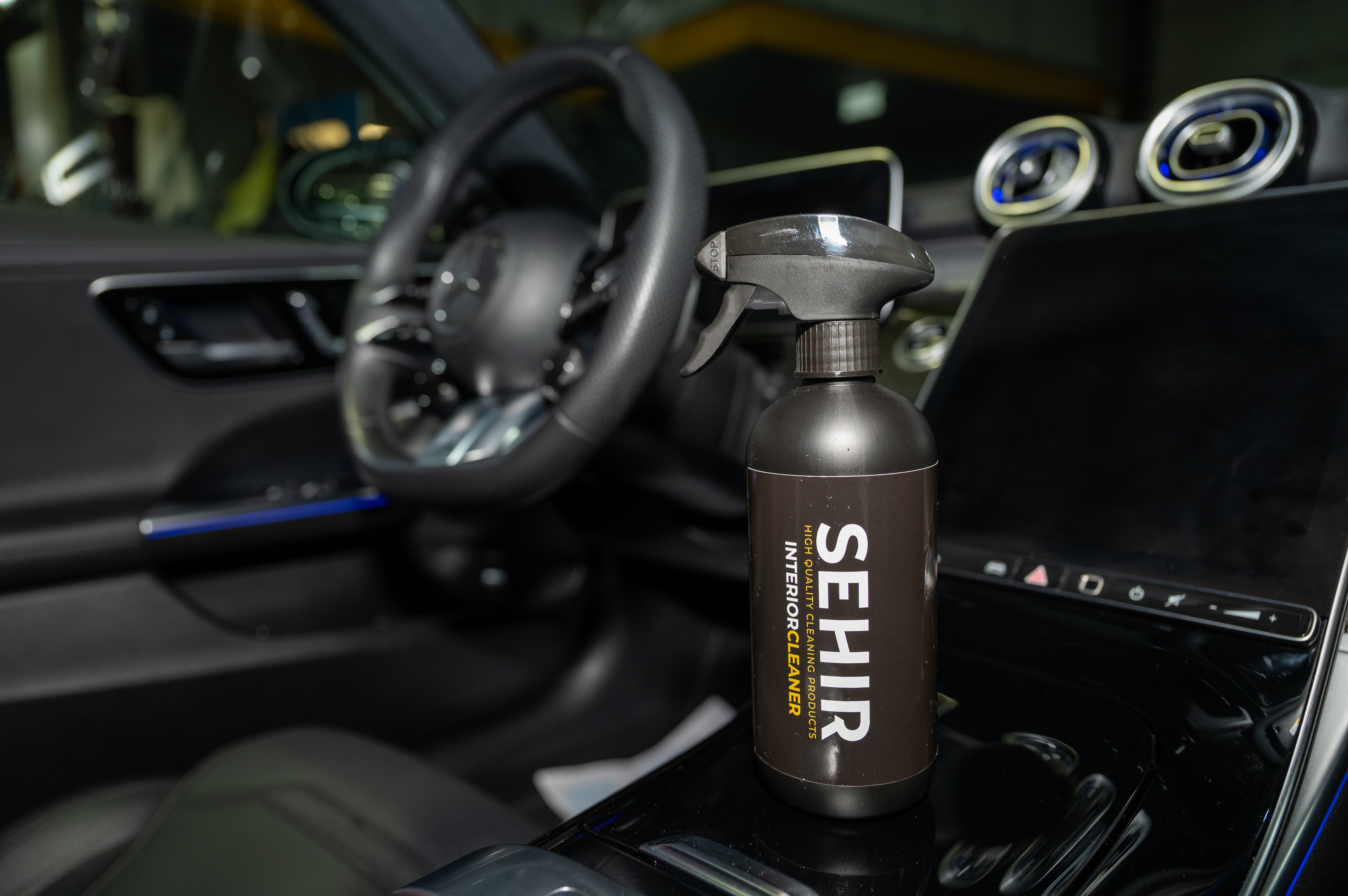 SEHIR car interior cleaner bottle on a car dashboard