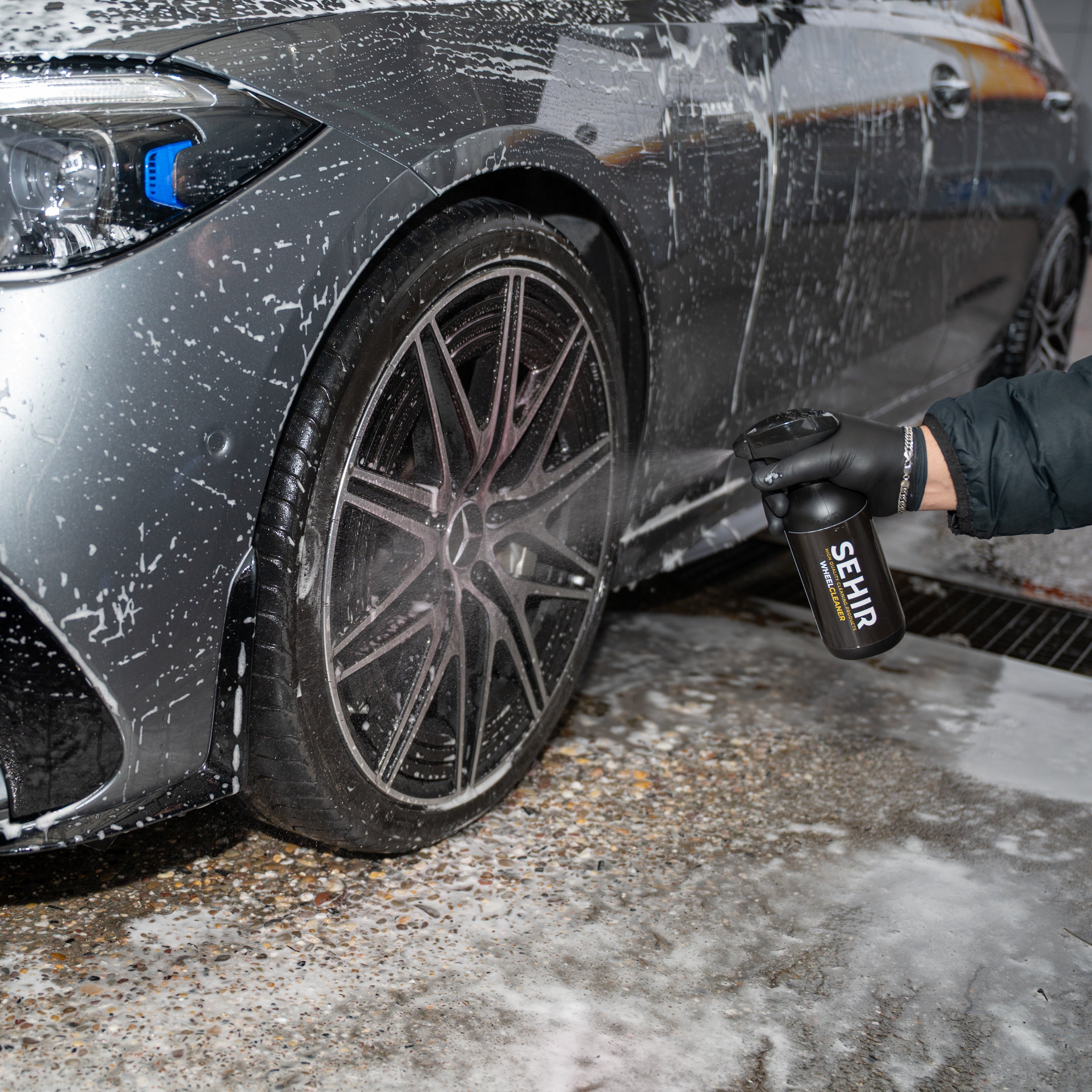 Car being washed with SEHIR Wheel Cleaner, focusing on the wheel