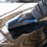 Person cleaning a car with a Clay Mitt 