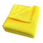 Folded yellow microfiber cloth on a white background