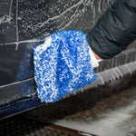 Person cleaning a car with a blue microfiber Wash Mitt.